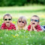 5 kids lying on the grass