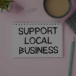 A pad of blank paper with the words SUPPORT LOCAL BUSINESS written on it